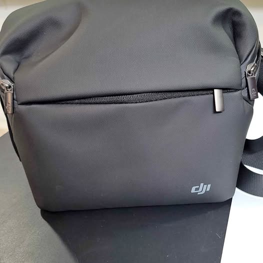 DJI drone shoulder bag, gray fabric with front zipper and DJI logo