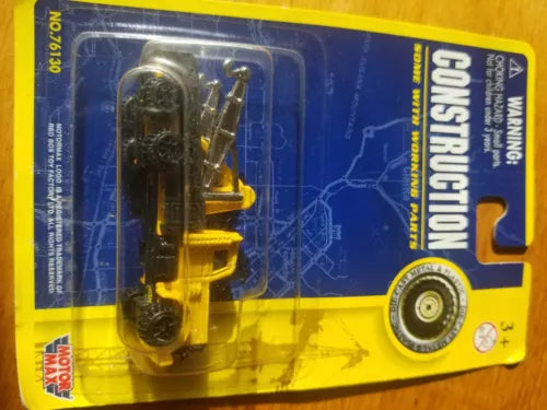 Yellow construction front loader diecast toy in blister packaging on card