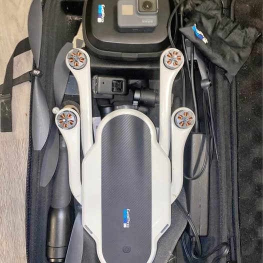 Gray folded drone with four prop motors and front camera module