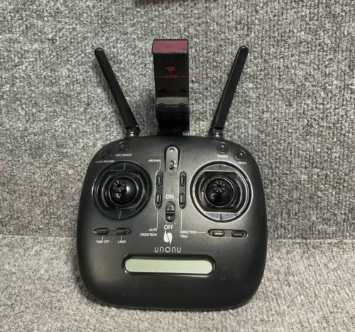 Black drone remote controller with two antennas and central control panel