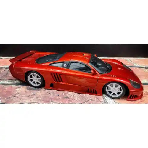 Red diecast 2-door coupe car, front 3/4 view with silver wheels and black hood stripe