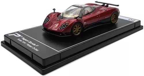 Red diecast model car with black display base