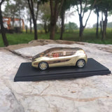 Gold and black diecast model car on display base, 1:43 scale
