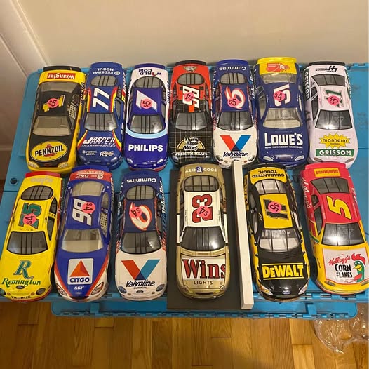 NASCAR diecast car set with multiple colorful race cars in a tray, numbered