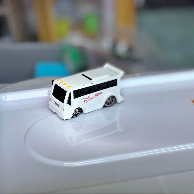 Diecast Disney World transport bus, white shell with side graphics and wheels