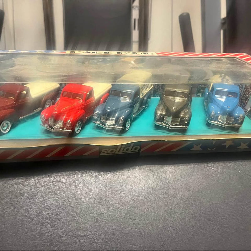 Diecast car set in display case with red, teal, gold, and blue cars