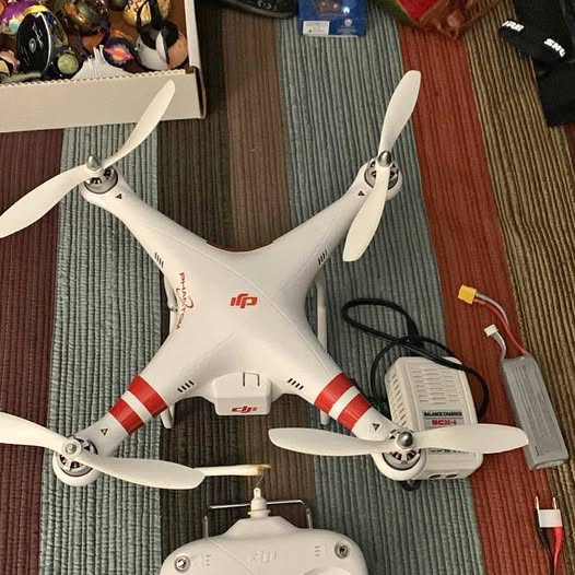 DJI Phantom drone with four white propellers and white body, front view