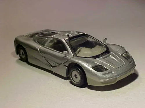 Silver race car diecast model with black front vents and open cockpit