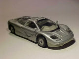 Silver race car diecast model with black front vents and open cockpit