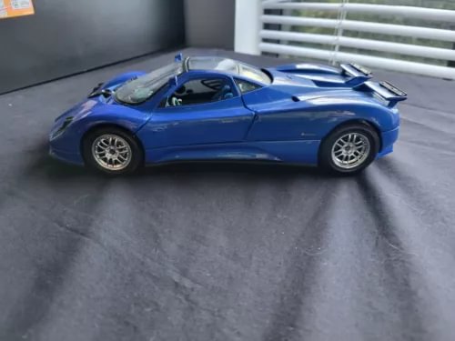 Blue sports coupe diecast model car with rear spoiler and hood vents