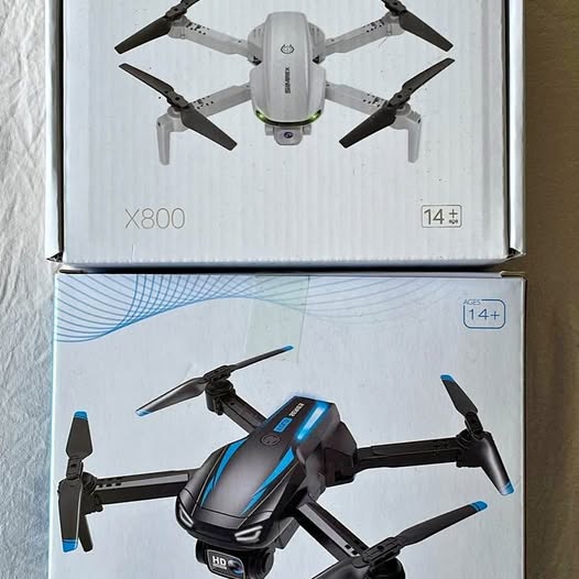 Black HD quadcopter drone with 4 propellers, shown in retail box