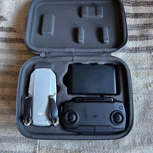 DJI drone in gray hard case with remote controller and landing accessories