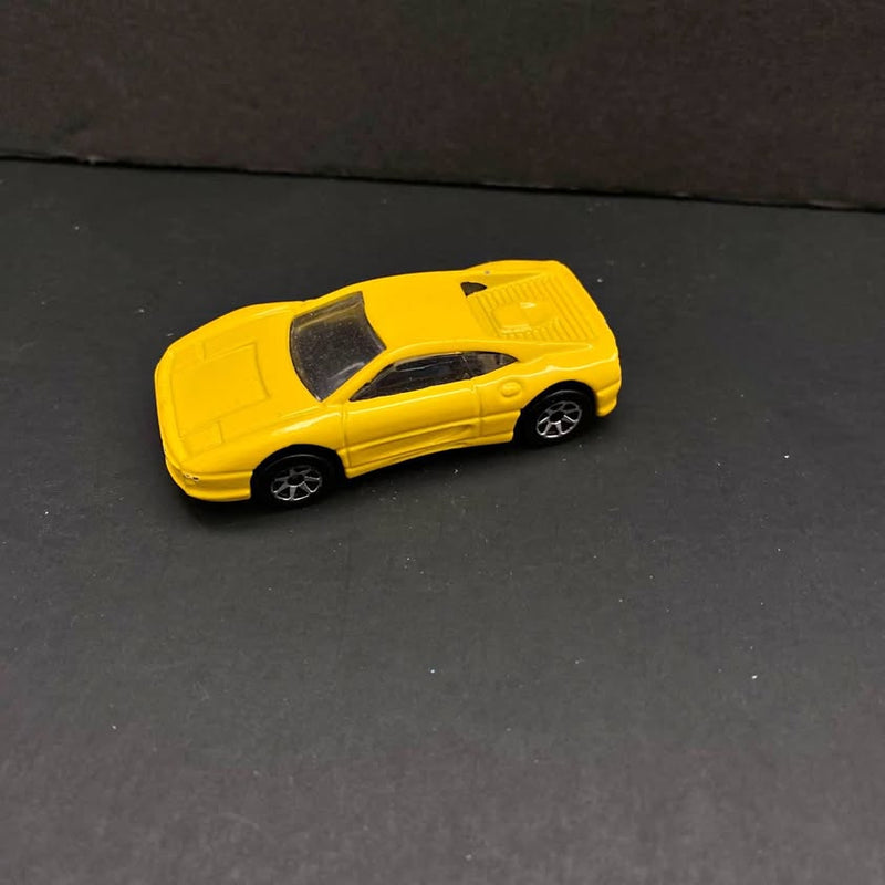 Yellow diecast sports car with black window and wheels