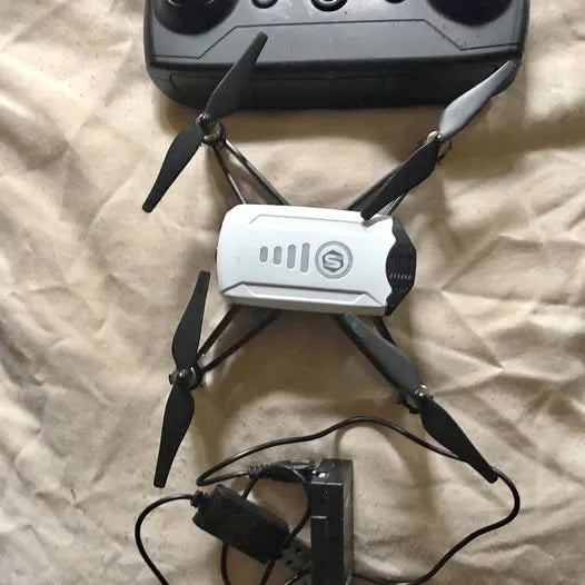 Foldable quadcopter drone with white body and four propellers