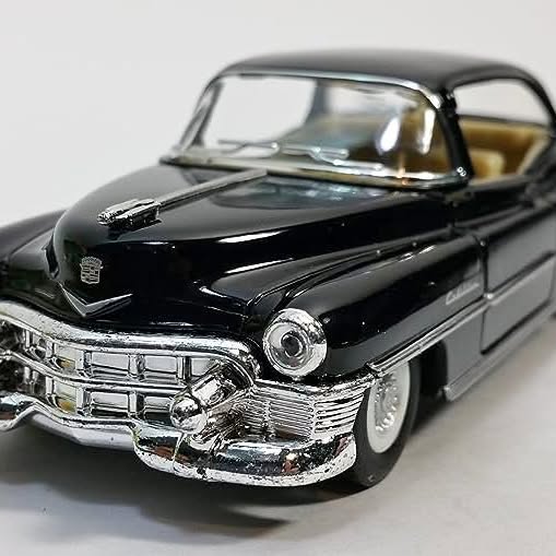 Black Cadillac 1953 diecast coupe model with chrome grille, headlights, and bumper