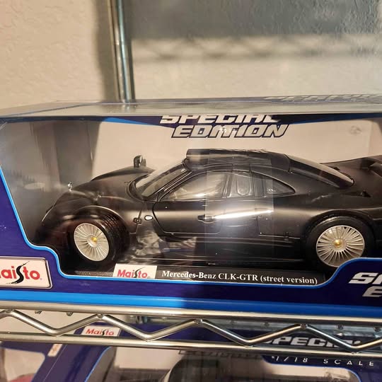 1:18 scale matte black Mercedes-Benz CLK-GTR diecast model car, front 3/4 view