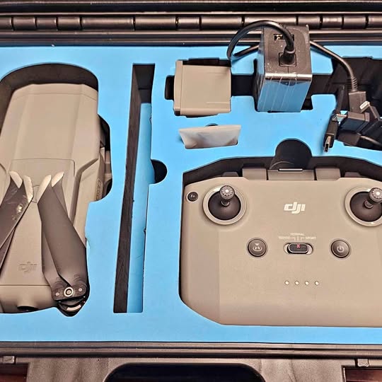 DJI drone controller with dual joysticks and built-in screen, beige