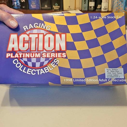 1:24 scale diecast racing car collectible in retail box, blue and yellow checkered