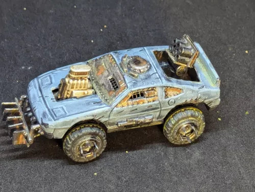 Light blue custom diecast car with gold details, rugged wheels and front accessories