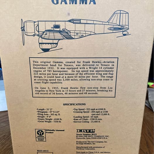 Diecast airplane model in blue and white on display box, side view