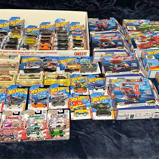 Bulk Hot Wheels diecast vehicles in assorted blister packs, cars and ships