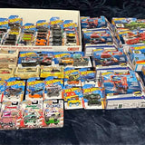 Bulk Hot Wheels diecast vehicles in assorted blister packs, cars and ships