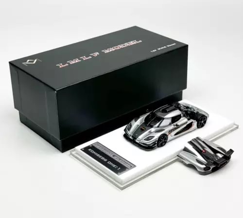 Diecast metal racing car set with silver sports car and black rear wing pieces