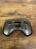 Gray drone controller with dual thumbsticks and button cluster