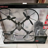 Quadcopter drone with four propellers, shown in retail box packaging