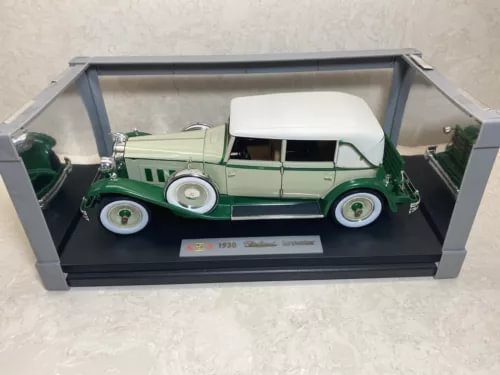 Cream and green 1930 diecast car in a clear display case with base