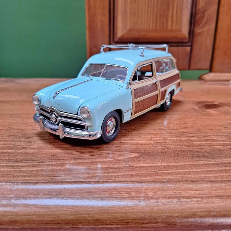 Light blue diecast classic Plymouth PA car with wood-side paneling and chrome front grille