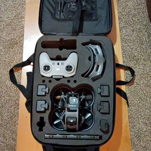 Foldable quadcopter drone in hard-shell carrying case with controller attachments