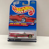 Hot Wheels diecast 1959 Caddy car model in red with yellow flame decals, on card