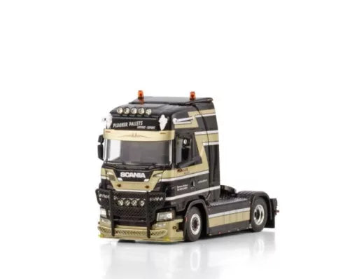Die-cast truck cab in black and beige, front grille and headlights visible