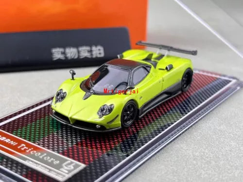 Lime green racing sports diecast model car with black wheels on display base