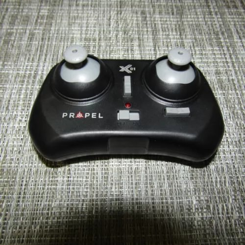 Black micro drone controller with two thumbsticks and PROPEL X01 label