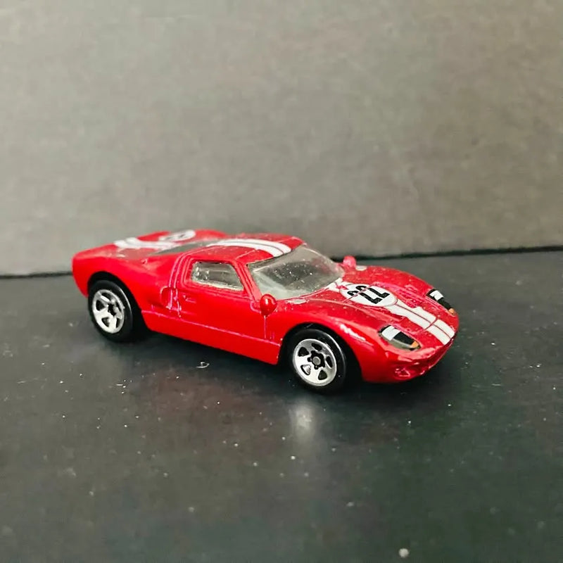 Red Ford GT40 diecast race car with white racing stripes, black wheels