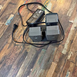 Drone battery charging station with three battery slots and connected power cables