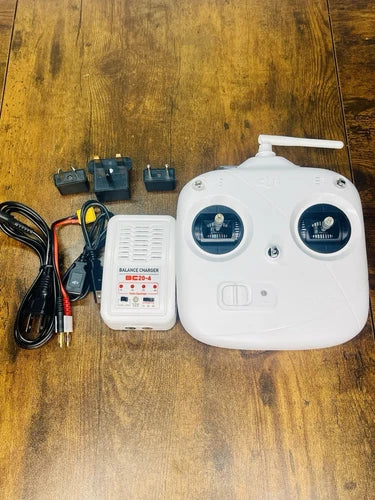 DJI Phantom white remote controller with antenna, charger, and power cables