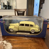 1:18 diecast model car, light yellow, in clear display case