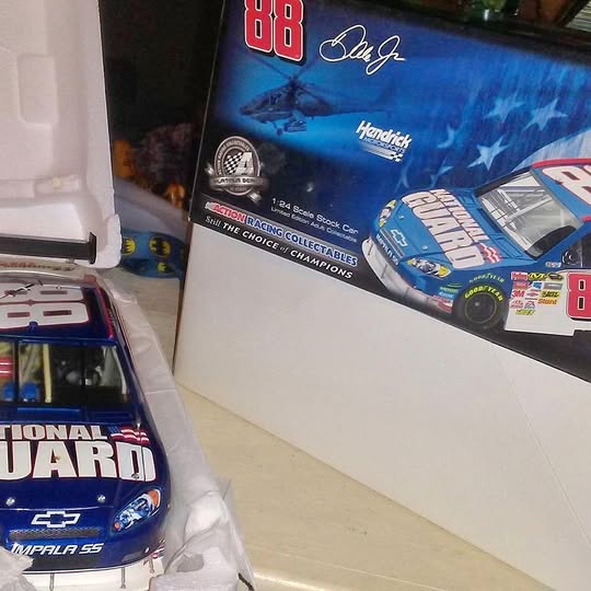 Blue diecast racing car model in retail box with red race number 88