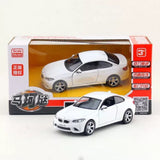 White 1:36 diecast sports car model with openable door, in retail box