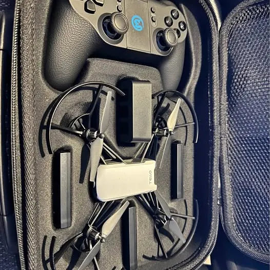 Drone carrying case interior with compact quadcopter and controller grips