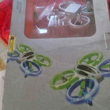 Glow stunt drone set: four quadcopters with green frames and blue LED light rings
