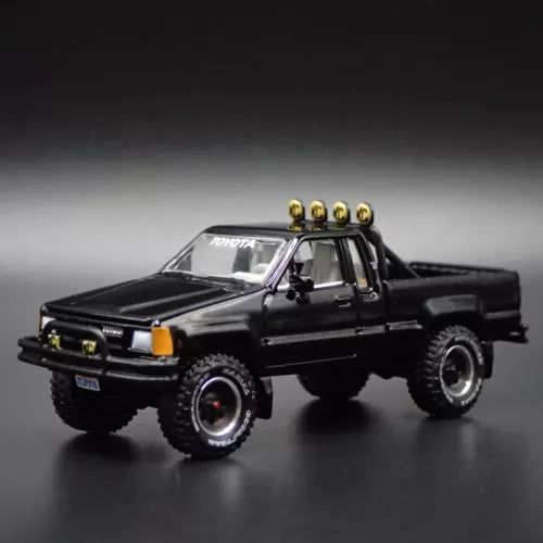 Black 1/64 scale diecast pickup truck model with roof light bar and bull bar