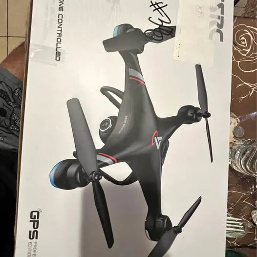 Gray quadcopter drone with front camera and four propellers, foldable arms