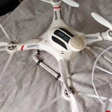 White quadcopter drone with visible propellers and front control panel