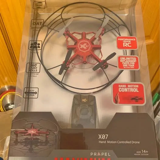 Mini hand-motion controlled drone in retail box with controller and propellers