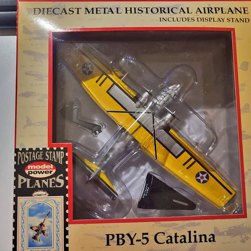 Diecast PBY-5 Catalina airplane model with yellow and black stripes, in display box
