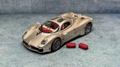 1:64 scale gold racing diecast car model with red interior and small red parts